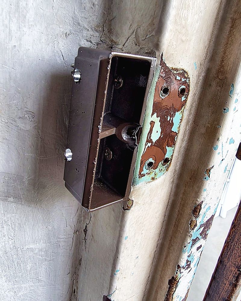 Old rusted rim lock on a white wooden door